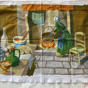 May include: A vintage kitchen tea towel with a colorful illustration of a woman cooking in a rustic kitchen. The scene includes a large pot over a fire, a table with a basket, a bottle, a pitcher, and a bowl. The text "VOTY FRANCE" is printed in the bottom right corner.