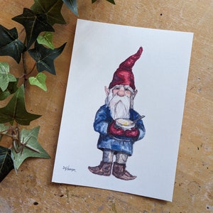 May include: Watercolor painting of a garden gnome holding a bowl of soup. The gnome wears a red hat, blue coat, and brown boots. A white beard and mustache frame his face. Green ivy is in the upper left corner.