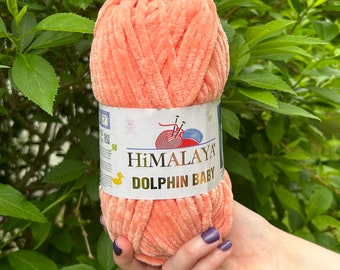 May include: A skein of peach-colored yarn labeled "HIMALAYA DOLPHIN BABY".