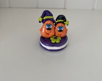 Polymer Clay Pumpkin Couple sitting on a Cookie