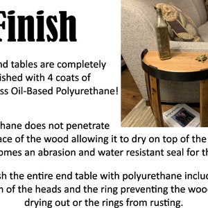 May include: A half-circle wooden side table with a black metal band. A decorative bottle and a small turtle figurine sit on the tabletop. A magazine is on the lower shelf. The table is next to a gray sofa.