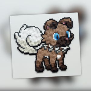 May include: A pixel art depiction of a dog, crafted from small, colorful beads. The dog features a brown body, white tail, and blue eyes. It is set against a white background, creating a striking contrast. The artwork is likely handmade.