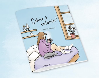 May include: A coloring book titled "Cahier à colorier³" by Karina Isabelle. The cover illustration depicts a person relaxing on a bed, holding a mug, with a cat nearby. A window and shelves with candles are also visible.