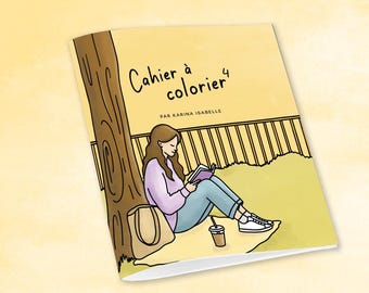 May include: A book cover with the title "Cahier à colorier 4" and the author's name, "Par Karina Isabelle." The illustration depicts a person reading a book under a tree, with a coffee cup and a tote bag nearby. The background is a park setting.