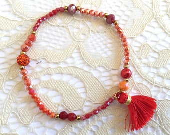 Elastic bracelet tones red, orange, gold, crystal beads, red pom pom cotton