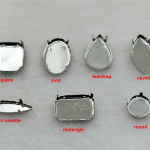 May include: Set of 8 silver metal settings for cabochons in various shapes: square, oval, teardrop, navette, thin navette, rectangle, and round.