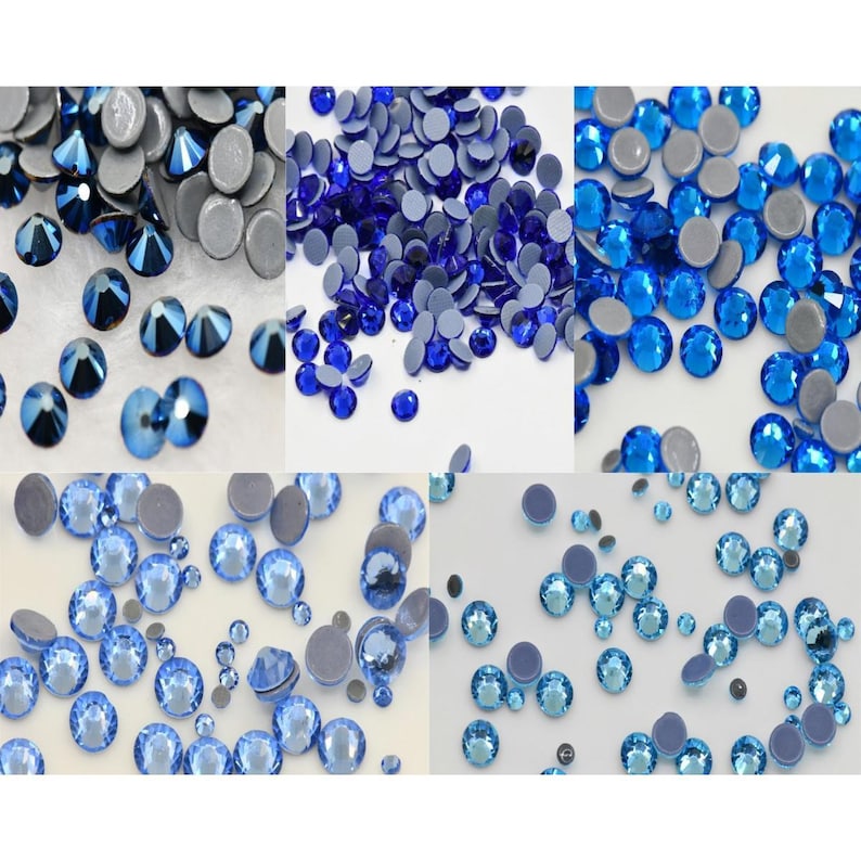 May include: Assortment of blue and light blue rhinestones with adhesive backs. The rhinestones are scattered on a white surface.