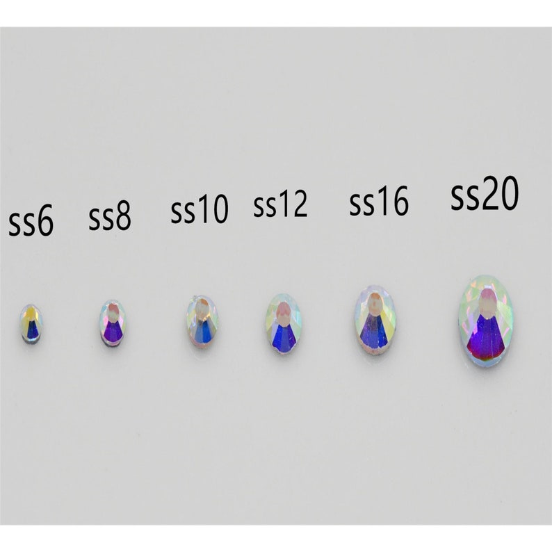 May include: A size comparison chart of clear iridescent rhinestones, labeled from smallest to largest: ss6, ss8, ss10, ss12, ss16, ss20.