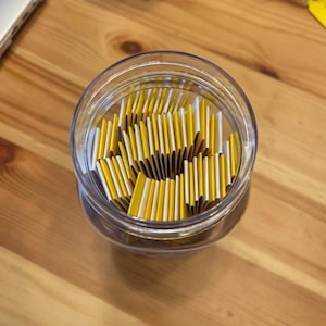 Image of Open WTF Jar showing the exact contents of 60 folded affirmations inside acrylic jar.