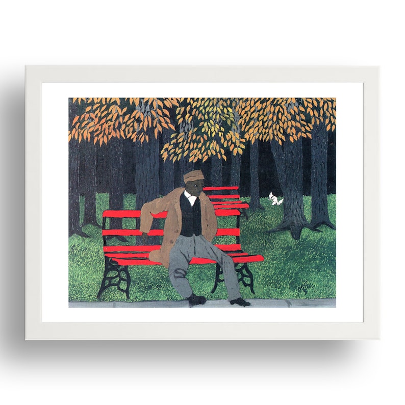May include: A man wearing a brown coat and a hat sits on a red bench in a park. The trees in the background have yellow and orange leaves.