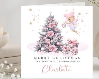 Pode incluir: Um cartão de Natal quadrado com uma árvore de Natal cinzenta decorada com poinsétias e ornamentos cor-de-rosa, uma fada voadora com cabelo cor-de-rosa e presentes empilhados. O texto diz: MERRY CHRISTMAS TO A BEAUTIFUL GRANDDAUGHTER Charlotte.