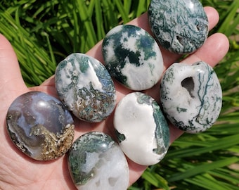 May include: Seven smooth, polished green and white agate stones. The stones are various shades of green and white with intricate patterns.