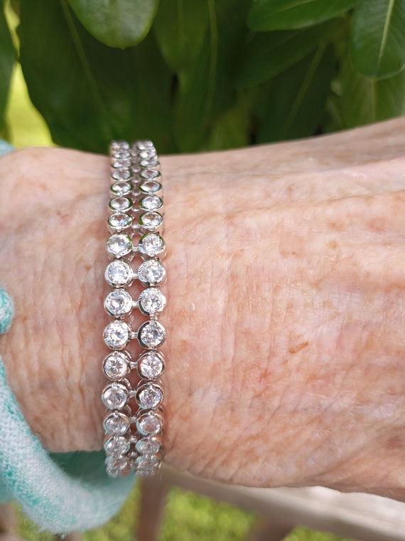 Sold at Auction: Gold plated sterling silver diamond tennis bracelet with  hidden clasp and safety