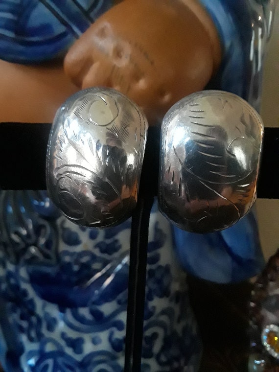 Sterling silver curved clip on earrings with decorative engraving