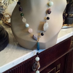 One long strand multi stone necklace designed with adjustable lenght