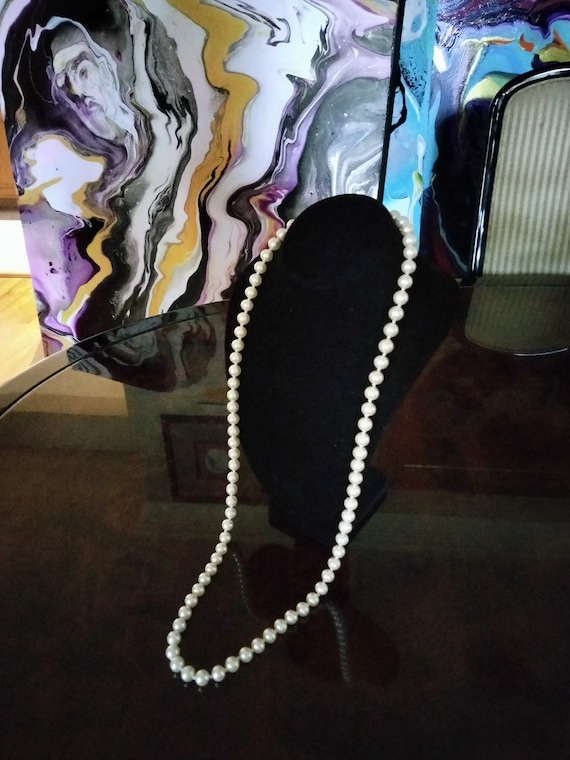 Long pearl hand knotted necklace by Carolee