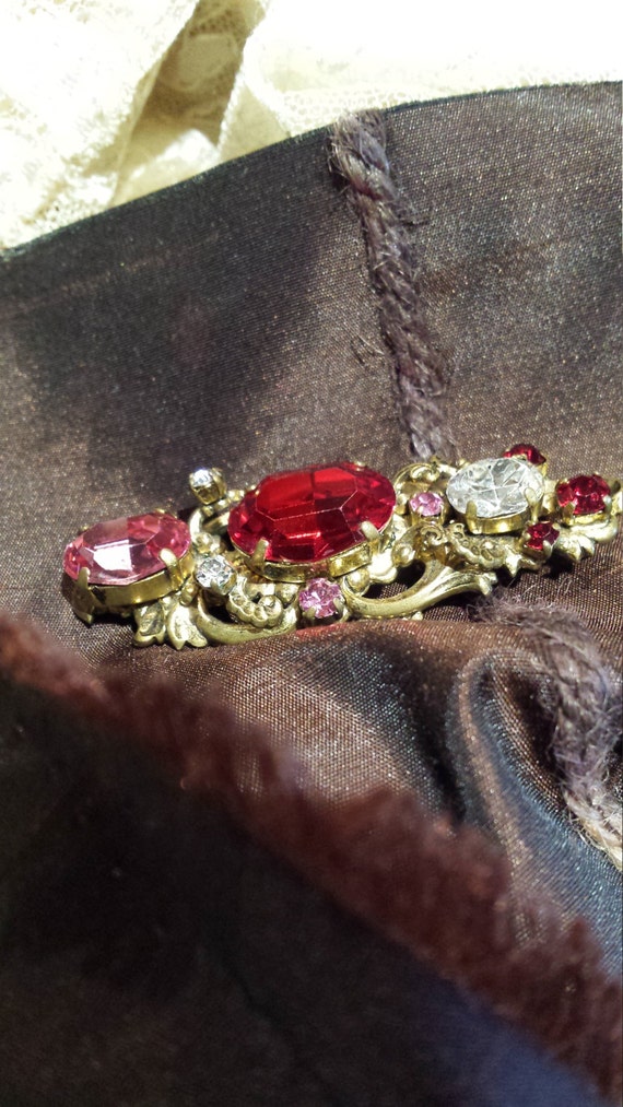 Vintage brooch in red and pink faceted pronged gla