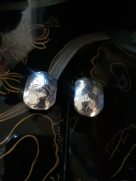 Sterling silver curved clip on earrings with decorative engraving View 2