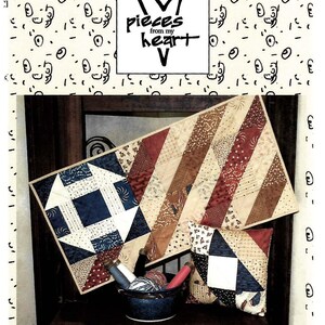 May include: A quilting pattern for a table runner and pillow featuring a red, white, and blue color scheme. The pattern is titled "#309 WAVE OUR COLORS" and is from the "Pieces from my Heart" collection.