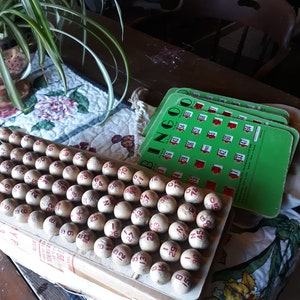 Vintage Bingo game complete set of wooden balls with numbers red graphics, original bingo board,49 green sliding bingo cards. No cage.