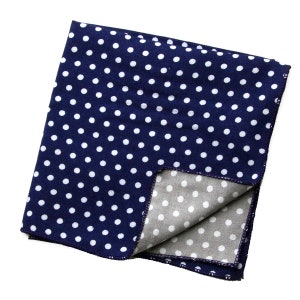 May include: A blue and gray reversible bandana with a white polka dot pattern. The bandana is folded in half and the gray side is visible.