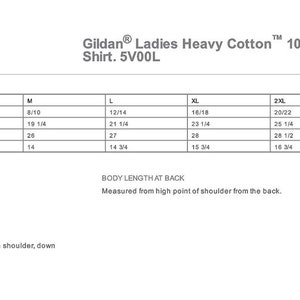 May include: A size chart for a Gildan Ladies Heavy Cotton 100% Cotton V-Neck T-Shirt. The chart shows the size, bust, body length at back, and sleeve length in inches for sizes S, M, L, XL, 2XL, and 3XL.