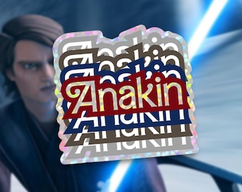 May include: A stack of colorful stickers with the word "Anakin" repeated multiple times. The stickers are holographic and have a glittery finish.