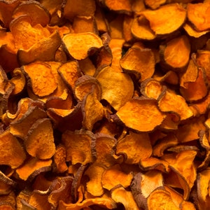 May include: A close-up of a pile of orange sweet potato chips. The chips are thin and crispy, and they have a slightly sweet flavor.