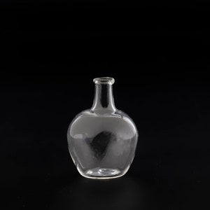 May include: A clear glass bottle with a rounded body and a narrow neck. The bottle is transparent, allowing a view through the glass. The design is simple and elegant, suitable for decorative purposes.
