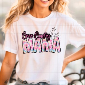 May include: White t-shirt with a pink and blue tie-dye design that says "Cross Country Mama" in black outlined letters with white stars above the text.