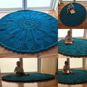 May include: A teal blue crocheted round rug with a large circular pattern in the center. The rug is shown in four different photos with a baby sitting on it.