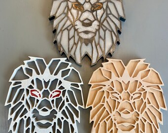 May include: Three geometric lion head wall decor pieces. One is white with gold accents, one is white with red accents, and one is natural wood with white accents.