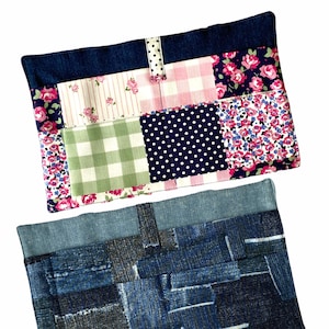 May include: Two rectangular patchwork fabric cases. The top case features a denim border and a patchwork design with floral, polka dot, and gingham patterns in pink, white, and green. The bottom case is made of denim patches in various shades of blue.