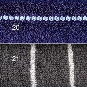 Op de afbeelding: Een gesplitste afbeelding met twee texturen van badstof. Het bovenste gedeelte is donkerblauw met een horizontale witte geborduurde lijn met het label 20. Het onderste gedeelte is donkergrijs met verticale witte strepen met het label 21.