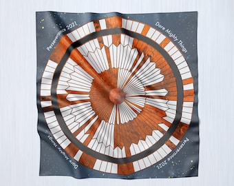 May include: A blue and orange circular design on a fabric scarf with the text "Dare Mighty Things" and "Perseverance 2021".