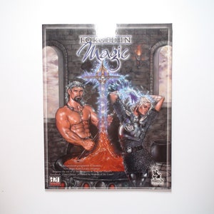 May include: A fantasy role-playing game book cover featuring a muscular man and a woman forging a sword in a fiery forge. The cover text reads "Forged in Magic".