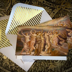 May include: A set of three greeting cards featuring a painting of women dancing in a swirling, ethereal setting. The women are dressed in flowing robes and have their arms raised in the air. The background is a soft, muted palette of browns, pinks, and blues. The cards are printed on high-quality cardstock and come with white envelopes.