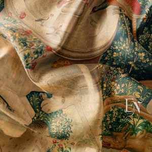 May include: A close-up of a tapestry featuring a detailed design of a woodland scene with various plants, flowers, and animals. The tapestry is folded in the centre, revealing a lighter background with a circular design. The tapestry is made of a woven fabric with a textured surface.