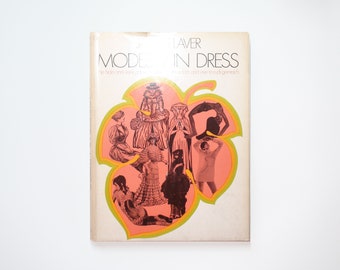 May include: A book cover with a pink and yellow leaf design featuring illustrations of women in various styles of dress. The title of the book is "MODERN DRESS" by James Laver.