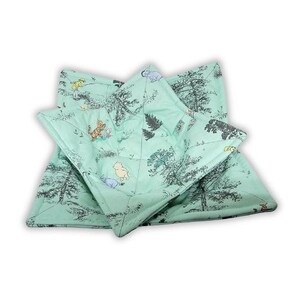 May include: A quilted fabric bowl cozy in a light mint green color featuring a repeating pattern of black line-art trees and small, colorful illustrations of cartoon characters including a yellow bear, a striped tiger, and a small blue creature.