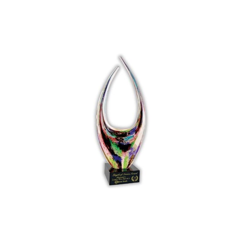 May include: A colorful art glass sculpture with a teardrop shape, featuring streaks of pink, green, blue, and black. The sculpture sits on a black base with engraved text. A decorative piece.