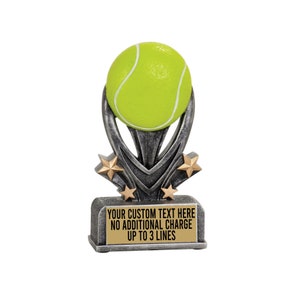 May include: Silver tennis trophy with a green tennis ball on top. The base has a gold plate with the text "YOUR CUSTOM TEXT HERE NO ADDITIONAL CHARGE UP TO 3 LINES".