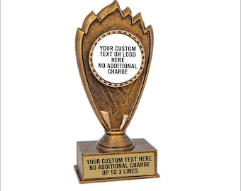 May include: Gold-colored trophy with a flame design. The trophy has a round, white plaque with the text "YOUR CUSTOM TEXT OR LOGO HERE NO ADDITIONAL CHARGE". The base of the trophy has a rectangular plaque with the text "YOUR CUSTOM TEXT HERE NO ADDITIONAL CHARGE UP TO 3 LINES".