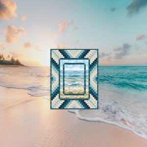 May include: A rectangular quilt featuring a central panel depicting a beach scene with ocean waves and sand. The quilt is framed by a geometric border composed of small, square fabric pieces in shades of deep navy, teal, and light cream.