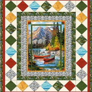 May include: A rectangular quilt featuring a central landscape panel of two red canoes on a lake with mountains and pine trees. The border consists of a mosaic of diamond-shaped fabric patches in red, green, yellow, blue, and grey stone patterns.