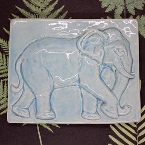 Handmade ceramic tile – Walking elephant in light blue, 11 x 8.8 cm