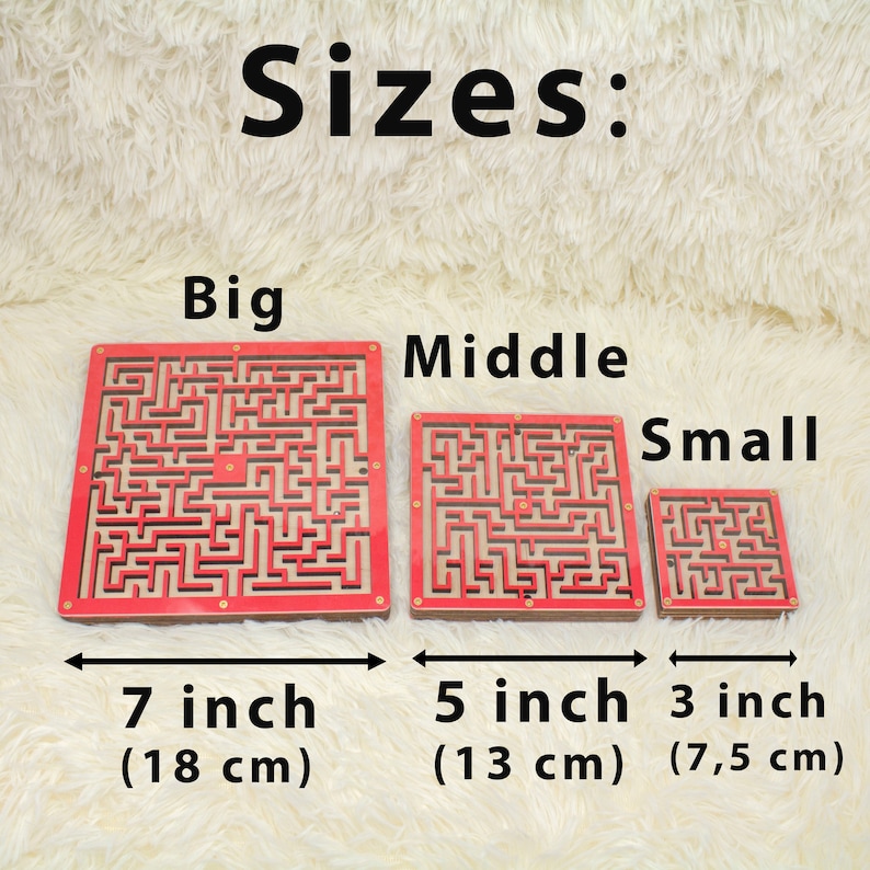 Three red wooden marble maze toys in different sizes labeled "Big," "Middle," and "Small" displayed on a fluffy cream surface. The sizes are shown as 7 inches (18 cm), 5 inches (13 cm), and 3 inches (7.5 cm), highlighting size options for buyers.