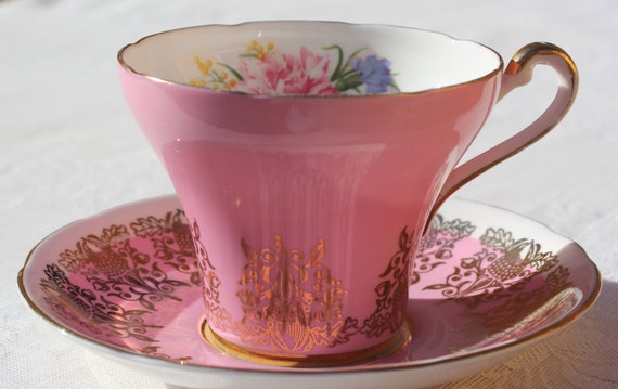 Stunning pink and gold teacup with floral bouquet acorn and