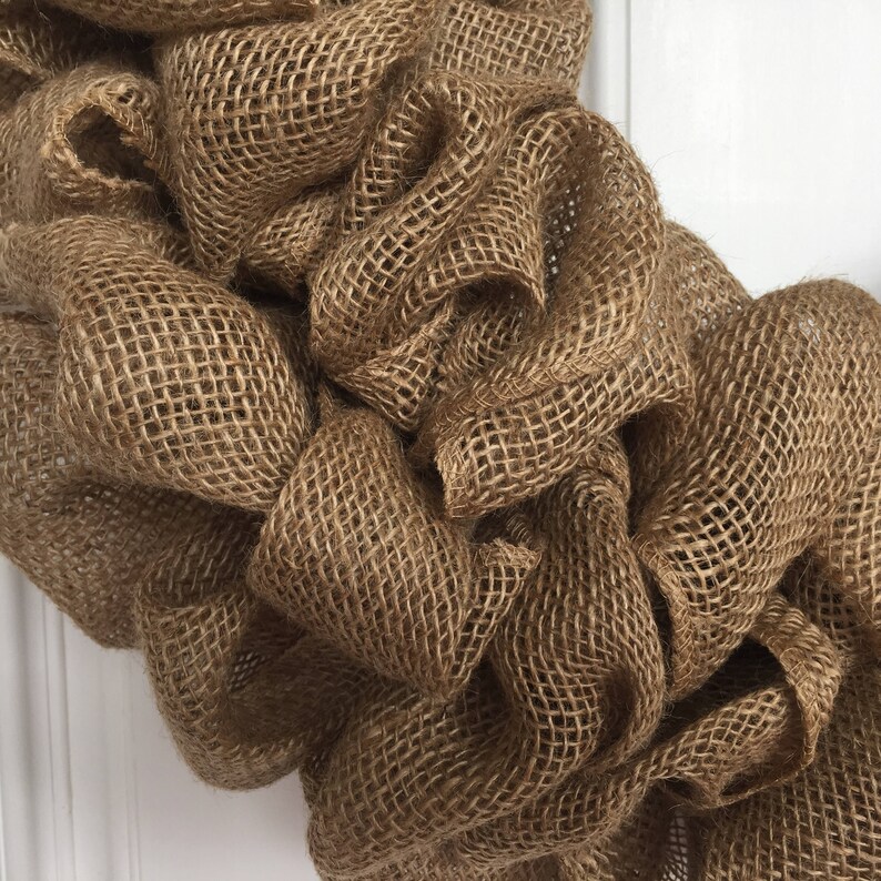 K&ouml;nnte beinhalten: Nahaufnahme einer braunen Jute-Kranz, die die Textur des Materials zeigt.