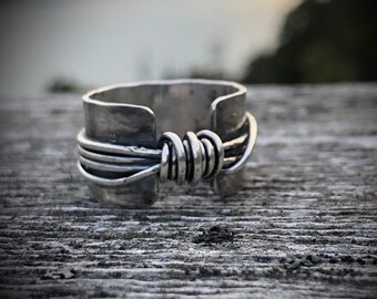 Hand made wide band sterling silver knot ring with open band.